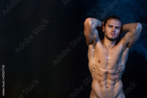 Sexy sport muscle fit strongface guy stripped on black isolated  font background with smoke photo