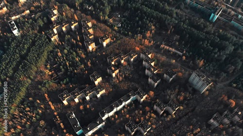 View of ghost city of Pripyat with Chernobyl nuclear power plant and sarcophagus on background. 35 years after disaster and evacuation. Traveling during pandemic of Covid-19 photo