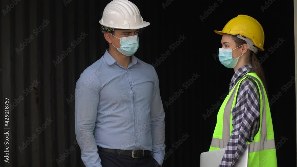 harbor worker wearing protective face mask discussion checking quality inside Containers box together at warehouse logistic in Cargo. teamwork of import export shipping during Coronavirus or Covid 19 harbor worker wearing protective face mask discussion checking quality inside Containers box together at warehouse logistic in Cargo. teamwork of import export shipping during Coronavirus or Covid 19