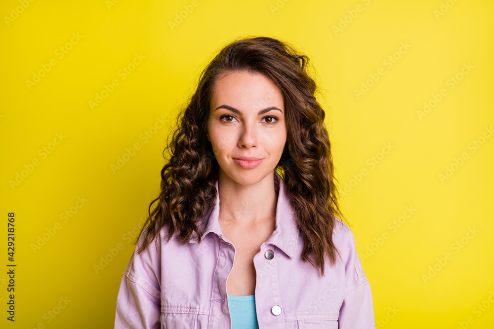 Portrait of attractive calm content wavy-haired girl wearing casual jacket isolated over bright yellow color background Portrait of attractive calm content wavy-haired girl wearing casual jacket isolated over bright yellow color background