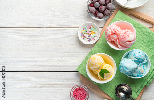 Fruit ice cream of three types on a salad napkin on a white background.