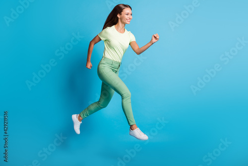 Full length body size photo of pretty girl jumping high running fast on sale isolated on bright blue color background