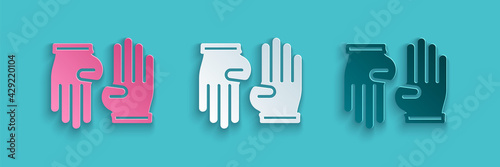 Paper cut Rubber gloves icon isolated on blue background. Latex hand protection sign. Housework cleaning equipment symbol. Paper art style. Vector