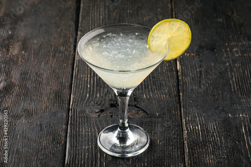 Side view on a glass of margarita cocktail with lime
