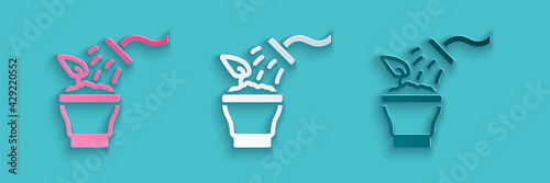 Paper cut Spraying a house plant with a spray gun icon isolated on blue background. Moistening of foliage. Care for home flowers. Paper art style. Vector