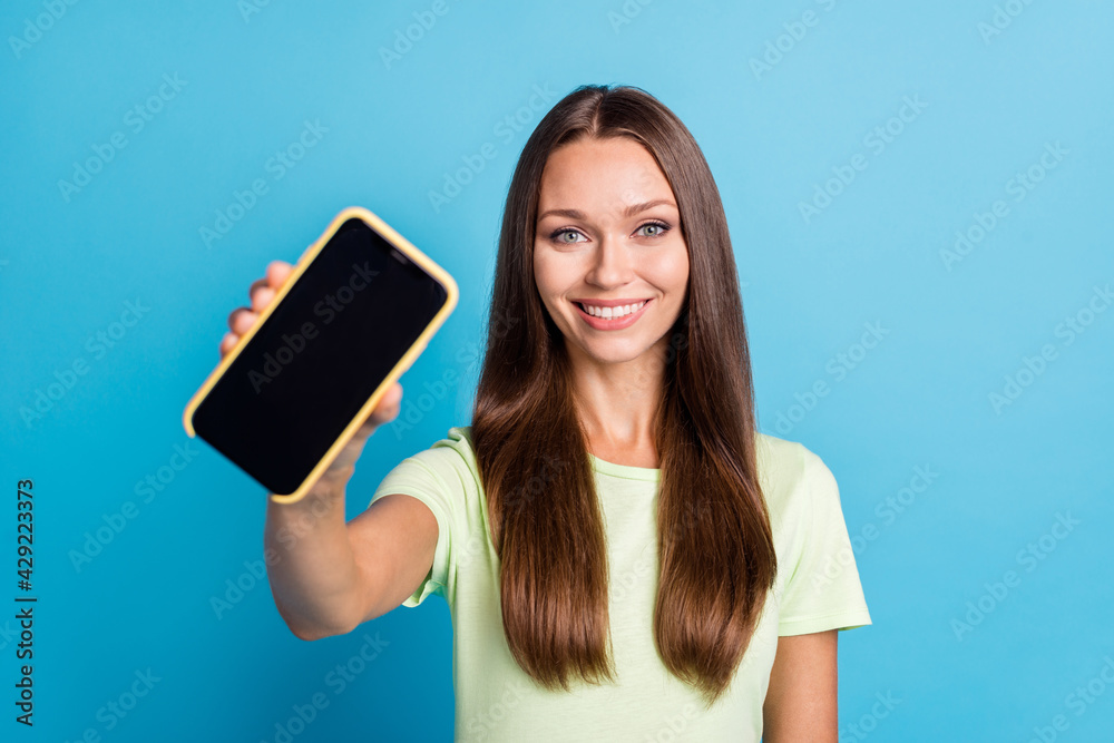 Photo of charming shiny young woman wear green outfit holding screen modern gadget isolated blue color background