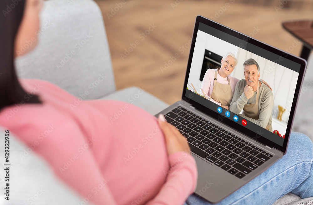 Unrecognizable Pregnant Woman Using Laptop At Home, Video Chatting With Senior Parents Unrecognizable Pregnant Woman Using Laptop At Home, Video Chatting With Senior Parents