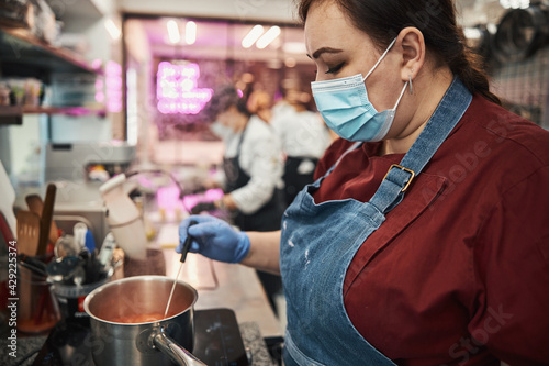 Professional kitchen staff following food handling safety protocols