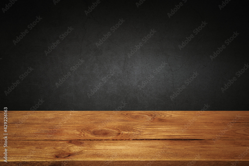 The background is blank wooden boards and a textured plastered wall with lighting and vignetting. The background is blank wooden boards and a textured plastered wall with lighting and vignetting.