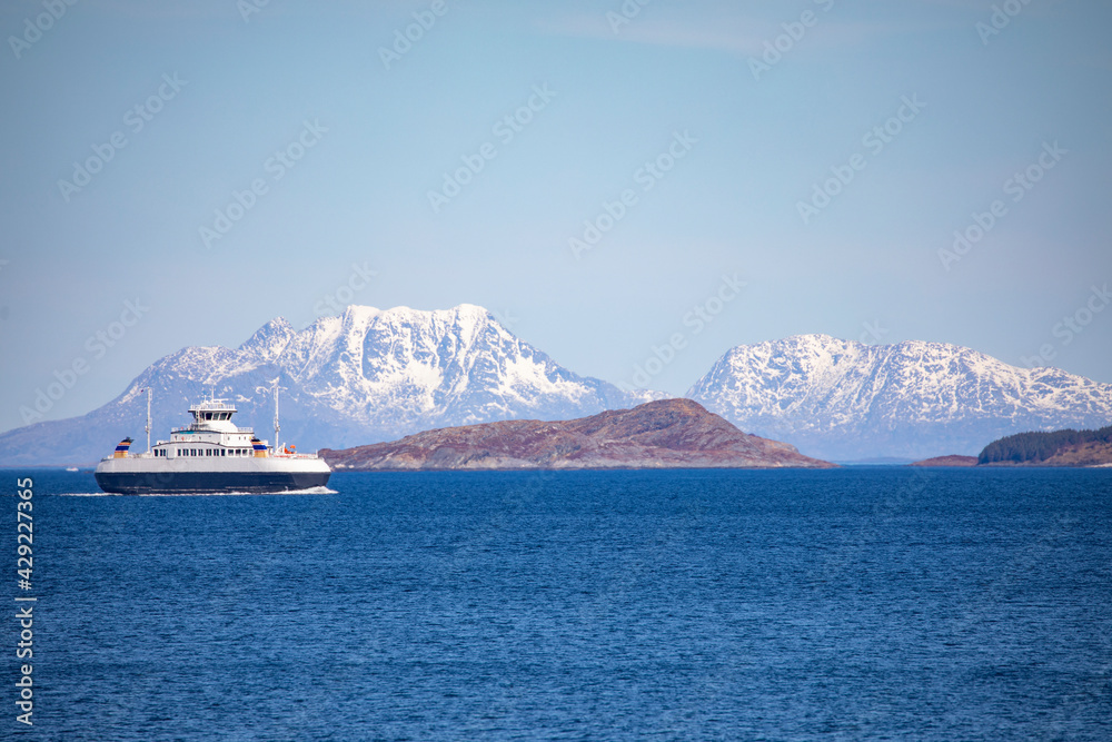 Car ferry in the bay,Horn,Dønnamannen island in backgrund,Helgeland,Nordland county,Norway,scandinavia,Europe	