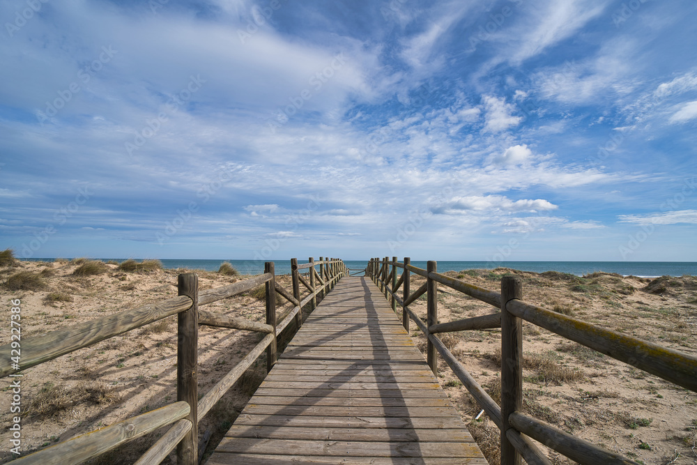 Wooden beach path headed toward the sea in the city of Valencia, in Spain.