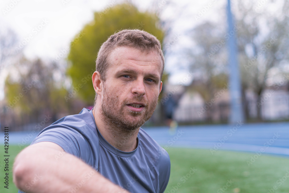 Fit man relaxing in a park setting, healthy lifestyle Fit man relaxing in a park setting, healthy lifestyle