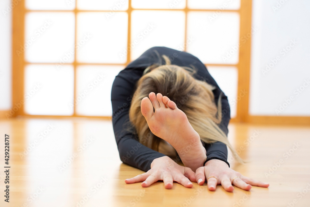 Young woman practicing yoga in a Japanese style room Young woman practicing yoga in a Japanese style room