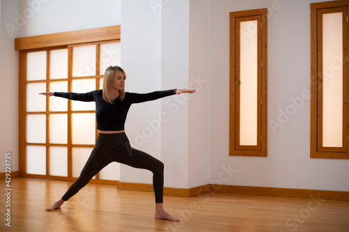 Young woman practicing yoga in a Japanese style room