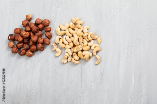 group of nuts on grey concrete background, healthy food concept 
