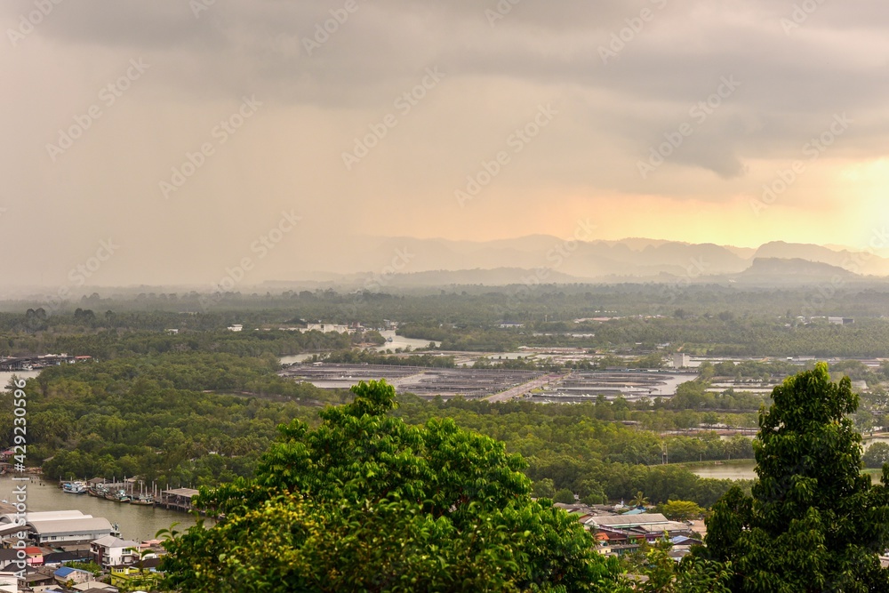 Obraz premium Aerial View of Fishing Village at Pak Nam Chumphon from Matsee Mountain During Sunset
