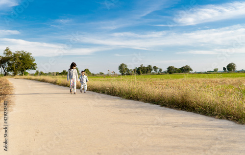 Girls and boys take a walk at the road with sky and clouds  Clearing day and Good weather in the morning.