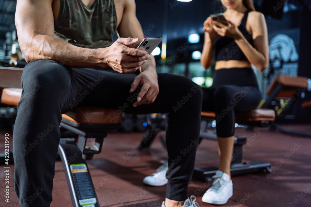 Member in Fitness gym using smartphone technology planing workout, Healthy Lifestyle bodybuilding, Athlete builder muscles lifestyle, Coach training online concept. Member in Fitness gym using smartphone technology planing workout, Healthy Lifestyle bodybuilding, Athlete builder muscles lifestyle, Coach training online concept.