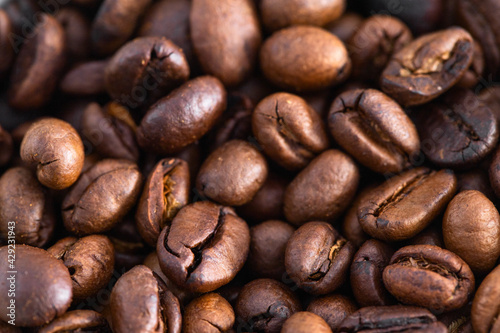 Close up of roasted coffee beans background. Detail and texture for design.