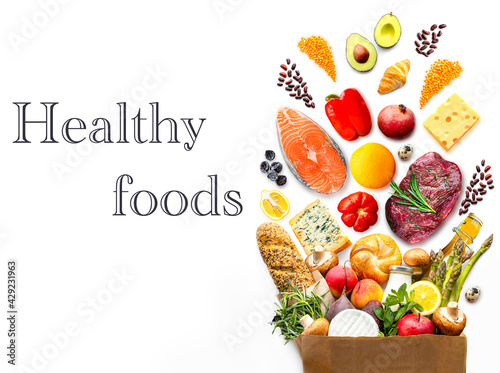 Fototapeta Naklejka Na Ścianę i Meble -  Full paper bag with healthy food.Healthy food background.Supermarket food concept. World Food Day.A complete package of healthy products from the supermarket.Shopping at the supermarket.Home delivery.