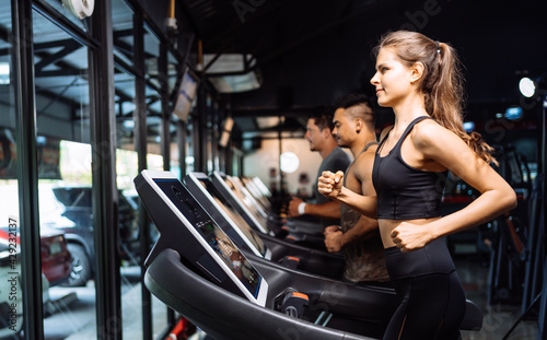 Sporty Group Running Cardio on Treadmills Exercise Burning Calorie in Fitness Gym Fit Body Healthy Lifestyle Athlete Muscle Building Strong Endurance in Health Club.