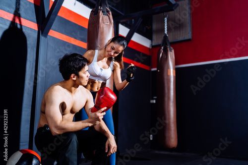 Asian Couple Boxing exercise in Fitness Gym Healthy Lifestyle bodybuilding, Athlete doing punching builder muscles lifestyle, Workout health care mobility concept.
