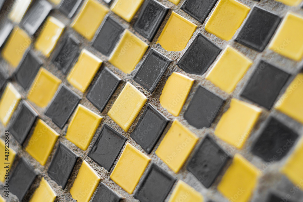 Fototapeta premium Close-up of a mosaic fragment of square ceramic tiles.