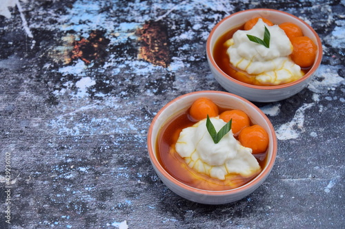 Bubur Sumsum Biji Salak, Indonesian rice flour porridge with sweet potato glutinous rice balls, served with palm sugar sauce, garnish with pandan leaf. Popular food during Ramadan photo