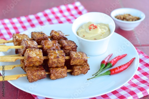 Tempeh Skewers served with spicy peanut sauce and fried onion