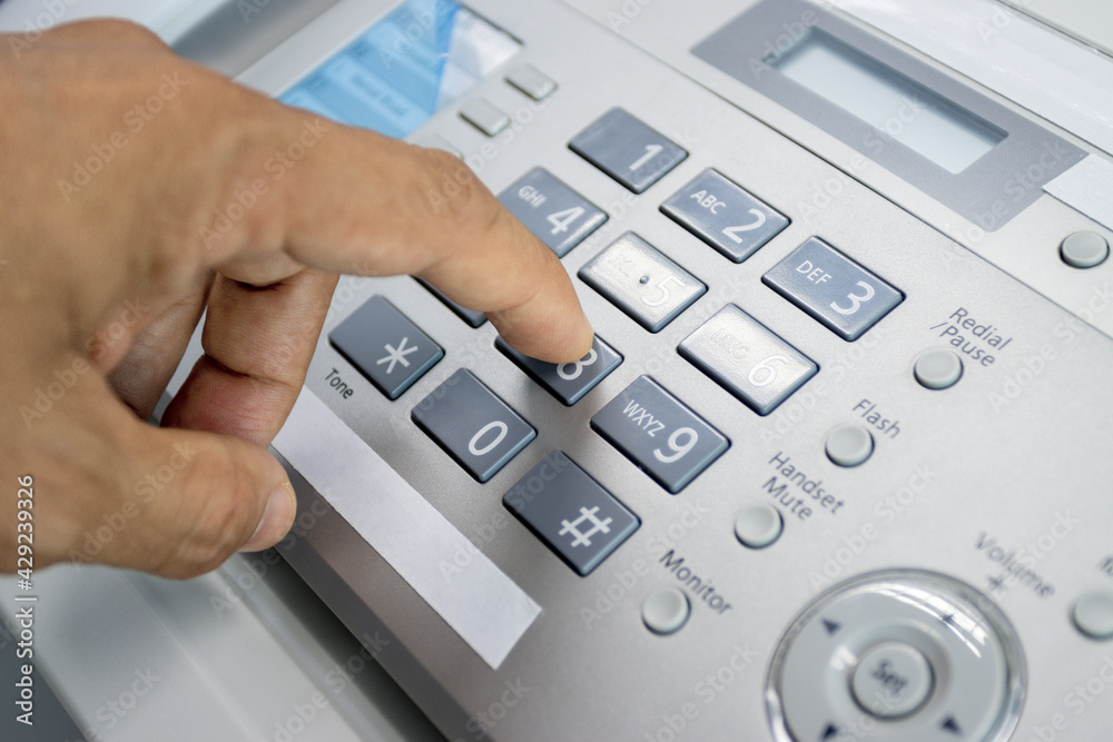 hand man are using a fax machine in the office, equipment for data transmission. hand man are using a fax machine in the office, equipment for data transmission.