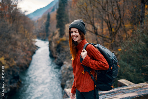 woman hiker with backpack in the forest in nature mountains river