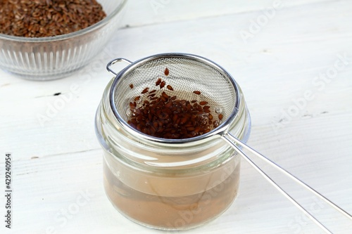 Making natural hair setting lotion for perfect hair. Boiled flax seeds filtered into a jar. Organic and  healthy  stylish hair lotion.
