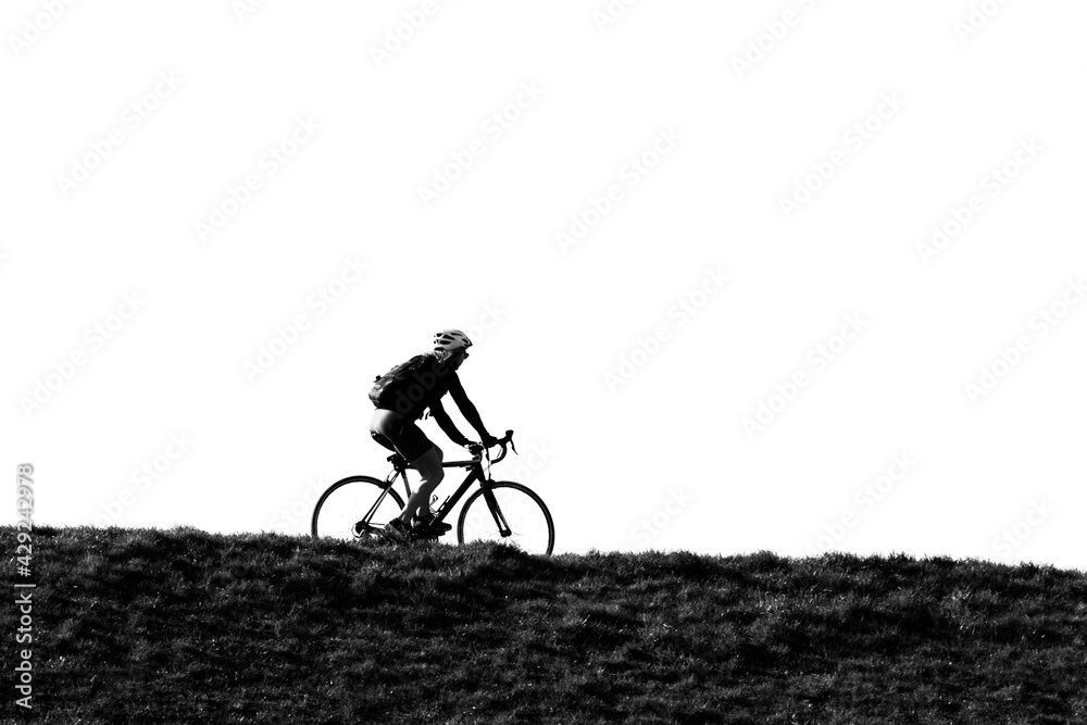 Φωτογραφία woman on bike on top of dike in holland
