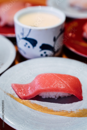 Sushi and Sashimi. Dishes of Sushi and Sashimi rolling on conveyer belt. photo