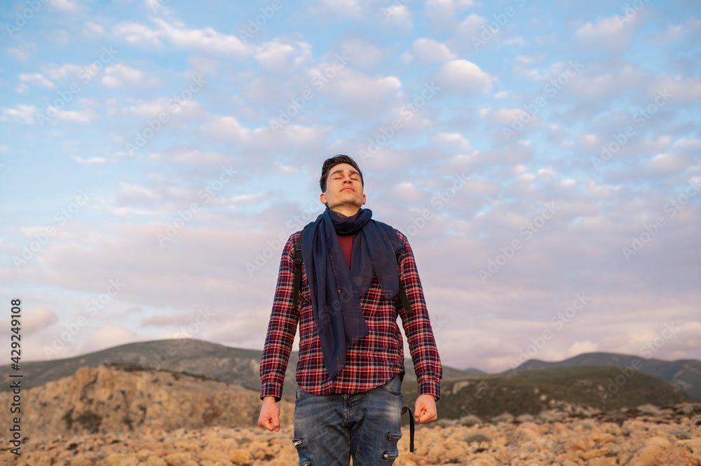Naklejka premium Portrait of handsome hiker man smiling looking up.