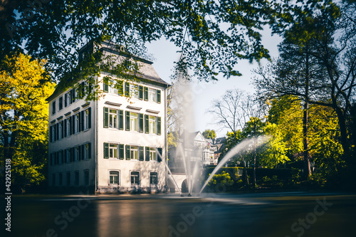 The Holzhausenschlößchen in Frankfurt in the Holzhausenpark. Nice long exposure of a moated castle. in front of this castle is a fountain