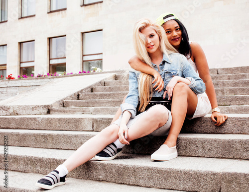 Two teenage girls infront of university building smiling  having fun traveling europe  lifestyle people concept close up