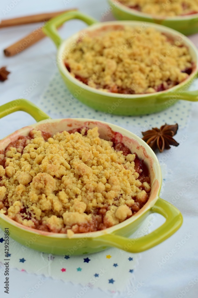 Plum crumble with spices on white background. Summer crispy fruit dessert. Tasty breakfast
Plum crumble with spices on white background. Summer crispy fruit dessert. Tasty breakfast