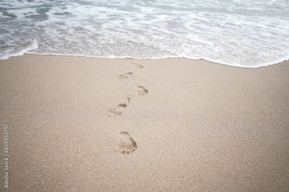 footprints on the white sand of the beach footprints on the white sand of the beach