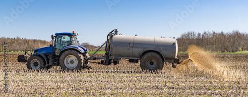 Tractor with slurry tanker fertilising in the field CP5140 photo