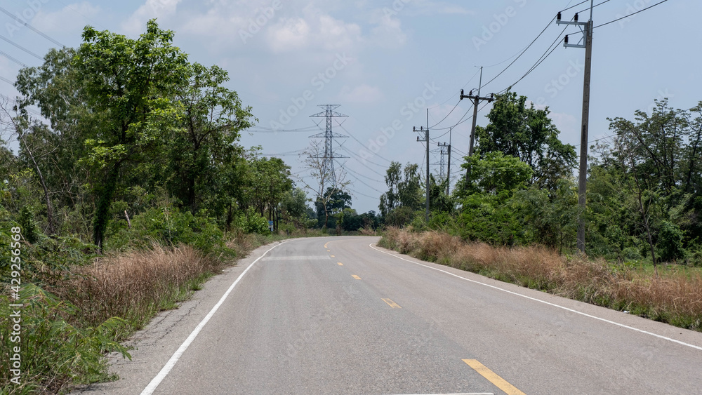 Rural roads coexist with high voltage poles that will bring prosperity everywhere.