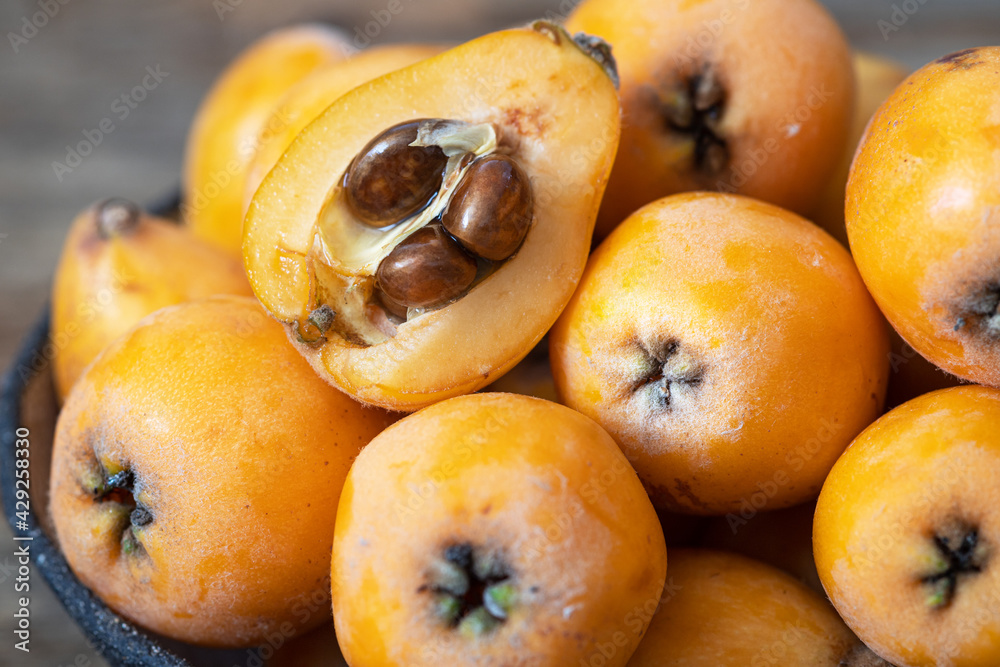 Fresh, ripe loquat on a wooden background.