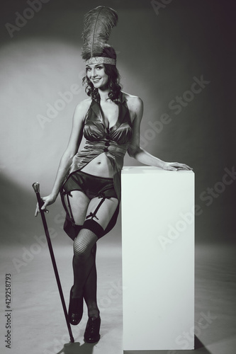 Photography Pretty woman in performer burlesque costume suit with cane Studio
