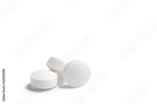 White round pills isolated on a white background with clipping path. A heap of small round meds. Health care and medicine concept