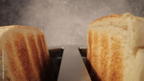 Toasted bread jumps out of a toaster - close-up shot - food photography