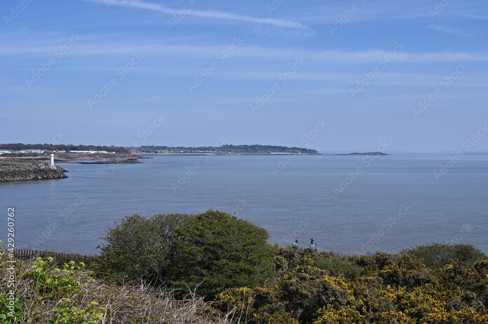 Barry Island, Wales, UK - April 17, 2021: Barry is a vibrant coastal town with a bustling High Street, gorgeous parks and colourful beach huts. Barry Island, Wales, UK - April 17, 2021: Barry is a vibrant coastal town with a bustling High Street, gorgeous parks and colourful beach huts.