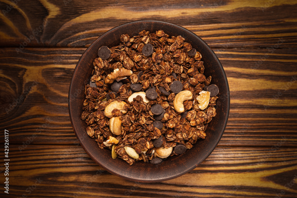 Fototapeta premium Chocolate granola cereal with nuts in a bowl.