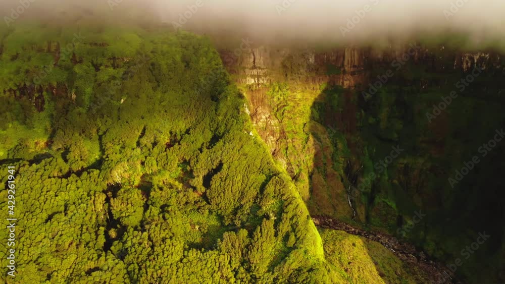 Aerial view of waterfall flowing between rocks Poco Ribeira do Ferreiro, Alagoinha, Flores Island, Azores, Portugal, Europe. Iconic mountains covered green vegetation, 4k footage