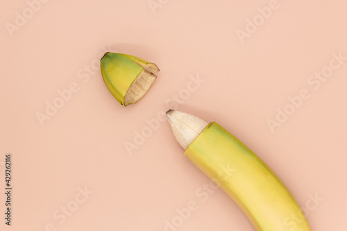 Male circumcision concept, banana with skin cut off photo