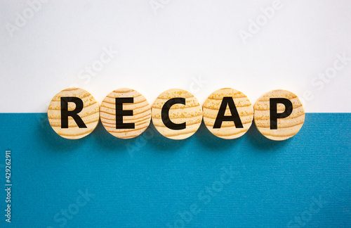 Recap symbol. Wooden circles with word 'recap' on beautiful white and blue background, copy space. Business and recap concept. photo